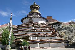 
Commissioned by a Gyantse prince in 1270, the Kumbum chorten was built in the style of a 108-sided mandala by craftsman from the Kathmandu Valley, and houses many excellent unique frescoes of Newari influence, a painting style originating in Nepal's Kathmandu Valley. It rises in eight stages to over 52m and has lots of images (Kumbum means '100,000 images') and 70 chapels. It is topped in typical Nepalese Buddhist style with the all-seeing eyes, the spire, umbrella and the pinnacle. The first five floors are four-sided, while the upper floors are circular, forming a huge three-dimensional mandala.
